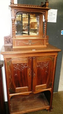 Lot 597 - French Art Nouveau carved mahogany cabinet with mirror back top