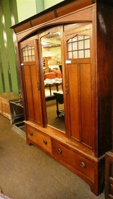 Lot 605 - Arts & Crafts oak triple wardrobe