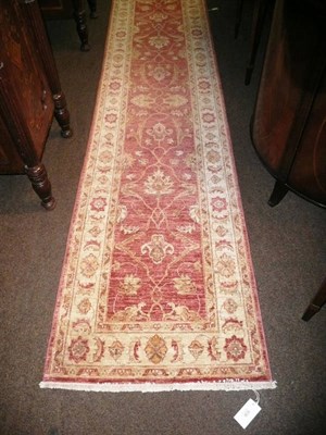 Lot 636 - Narrow Persian runner the field of linked vines