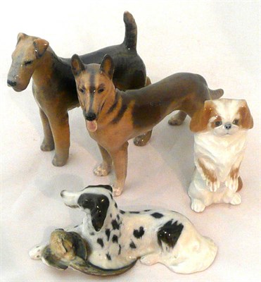 Lot 5 - Four Royal Copenhagen figures of a German Shepherd, an Airedale terrier, a Pekingese and an English