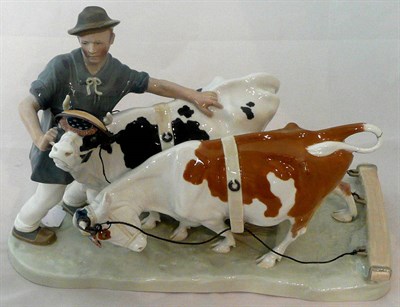 Lot 9 - A ceramic Meissen group of a man with two cattle (a.f.)