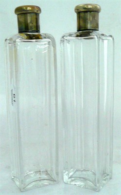 Lot 61 - Pair of large glass bottles with white metal mounts