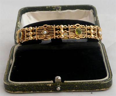 Lot 81 - A bracelet set with peridot and split pearl, stamped '15'