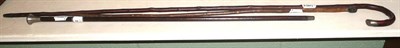 Lot 134 - A bamboo swagger stick carved with a dogs head, a swagger stock, a disciplinary cane, a white metal