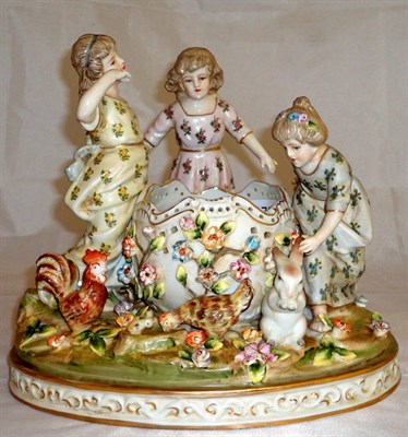 Lot 175 - A German figural group of three young girls playing with hens and a rabbit