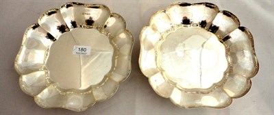 Lot 180 - A pair of silver dishes on four scroll feet, 41oz