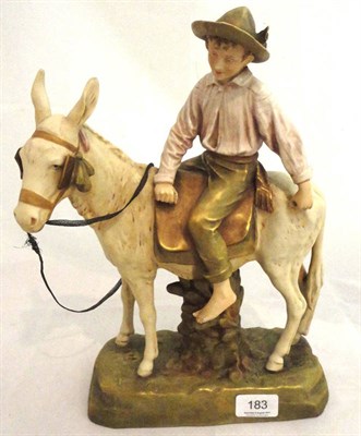 Lot 183 - Royal Dux figure of a young boy riding a donkey