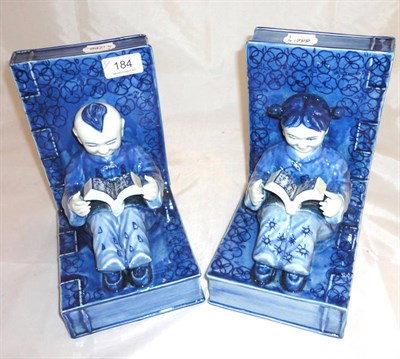 Lot 184 - Pair of modern decorative blue and white pottery bookends modelled as two oriental children reading