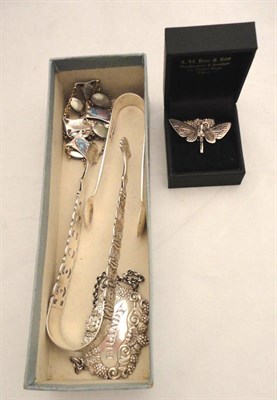 Lot 220 - A pair of silver sugar tongs, another, a Brandy bottle label, a necklace and a bracelet