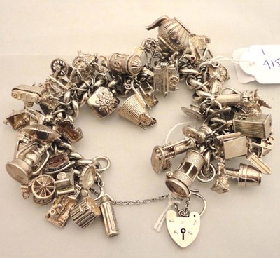 Lot 249 - A silver charm bracelet hung with numerous silver and other charms