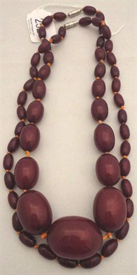 Lot 252 - Two cherry amber necklaces