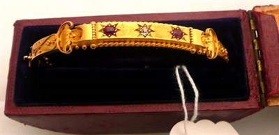 Lot 260 - A 15k bangle set with rubies and diamonds, cased