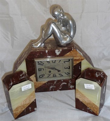 Lot 319 - An Art Deco marble 3 piece clock garniture, the mantel clock mounted with Spelter maiden