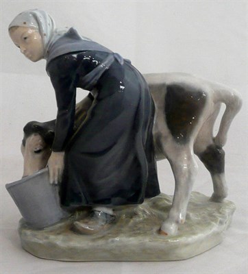 Lot 353 - A Royal Copenhagen figure of a milkmaid feeding a calf, model 779