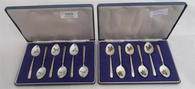 Lot 359 - Two sets of silver and enamel spoons