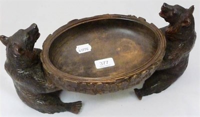 Lot 377 - A carved oval bowl supported by two carved black forest bears