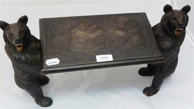 Lot 380 - A rectangular small footstool with carved top, supported by two black forest carved bears