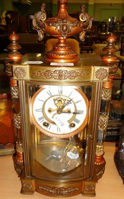 Lot 385 - A brass cased mantel clock with cut glass supports