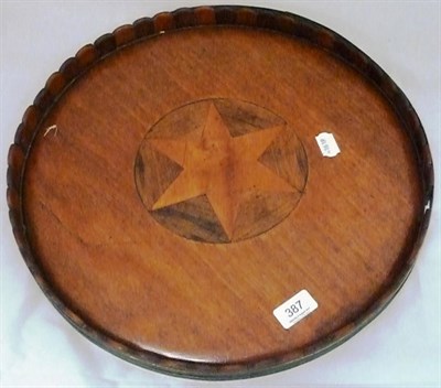 Lot 387 - Circular tray inlaid with a star and brass bound