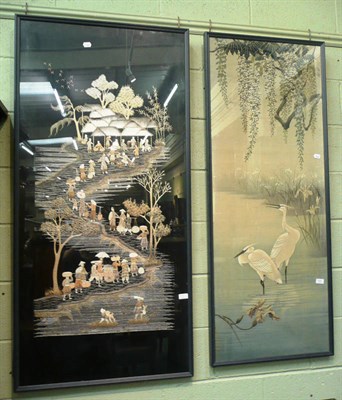 Lot 500 - An fabric framed panel of two storks and an embroidered panel of Oriental figures