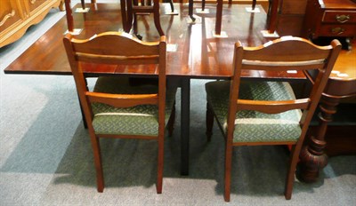 Lot 531 - An early 19th century mahogany drop leaf dining table and four chairs