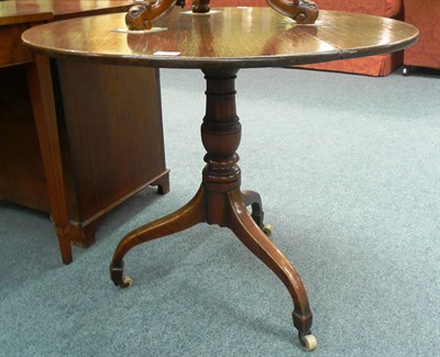 Lot 544 - An early 19th century oak tripod table