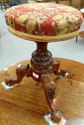 Lot 545 - A Victorian carved walnut revolving piano stool