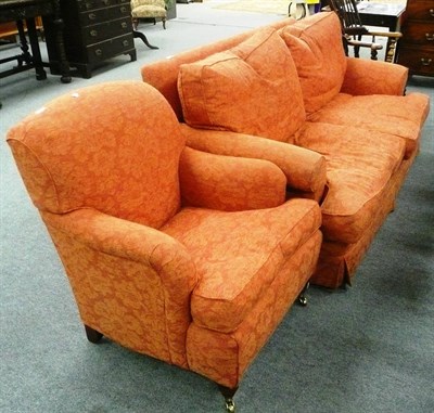 Lot 558 - Orange sofa and matching armchair with squabs