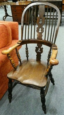 Lot 559 - A 19th century elm seated Windsor arm chair