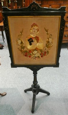 Lot 573 - A Victorian ebonised pole screen with embroidered panel