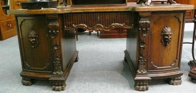 Lot 577 - An early 20th century German carved oak desk