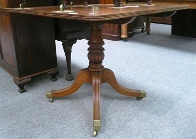 Lot 595 - A mahogany breakfast table on carved pedestal base