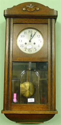 Lot 636 - A 1930's oak wall clock