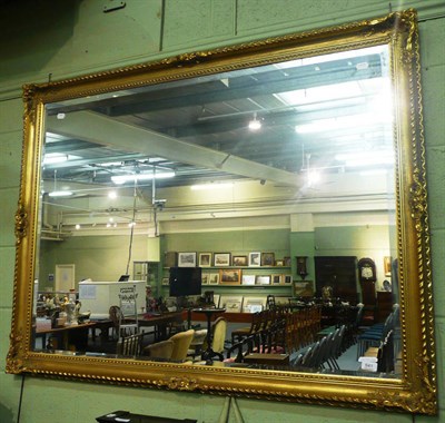 Lot 641 - A large modern rectangular gilt framed wall mirror