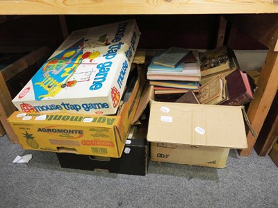 Lot 675 - Six boxes of assorted books, wicker fishing  basket, games including subbuteo, crossfire,...