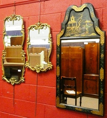 Lot 681 - A Chinoiserie lacquered wall mirror with a shaped top and two modern gilt framed wall mirrors