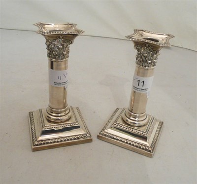 Lot 11 - A pair of loaded silver candlesticks
