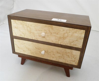 Lot 43 - A 20th Century Miniature Veneered Chest of Drawers of plain rectangular design, with two long...