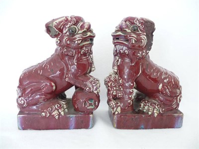 Lot 46 - A Pair of Chinese Sang de Boeuf Glazed Stoneware Dogs of Foo, 19th century, of traditional form...