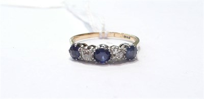 Lot 102 - A sapphire and diamond three stone ring