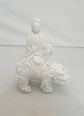 Lot 108 - A Blanc de Chine Figure of Guanyin, Qing Dynasty, the robed figure sitting on the back of a...