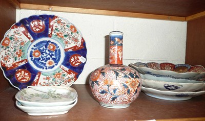 Lot 139 - Five Imari scalloped edge chargers, Imari bottle vase and stopper and two pottery dishes