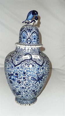 Lot 149 - A 19th century Dutch Delft fluted vase cover with a parrot finial decorated in under glazed blue