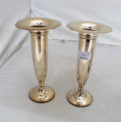 Lot 159 - A pair of silver hall marked loaded spill vases with broad inverted rims, on circular bases (2)