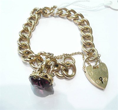 Lot 208 - A 9ct gold curb and lock bracelet with amethyst fob