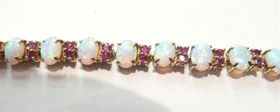 Lot 223 - An opal and ruby line bracelet