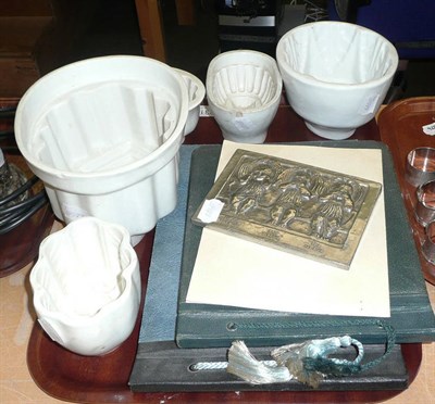 Lot 231 - Five assorted jelly moulds, pewter plaque, two photo albums and a small painting