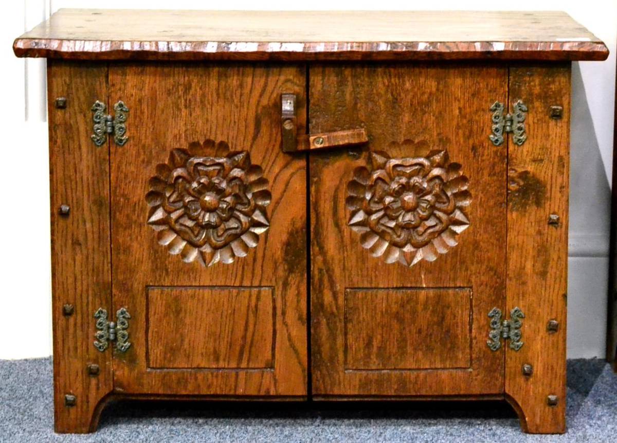 Lot 554 - A Jack Grimble of Cromer Oak Cupboard, the rectangular top above two doors each with a carved rose