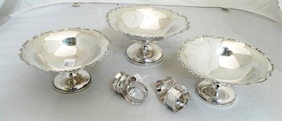 Lot 265 - Three silver bon bon dishes and four silver napkin rings (approx 20 oz)