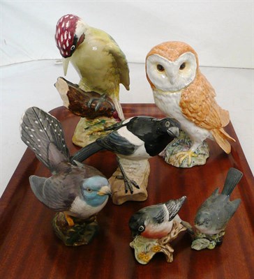 Lot 353 - Beswick figures of a barn owl, a woodpecker, a cuckoo, a magpie and two smaller figures